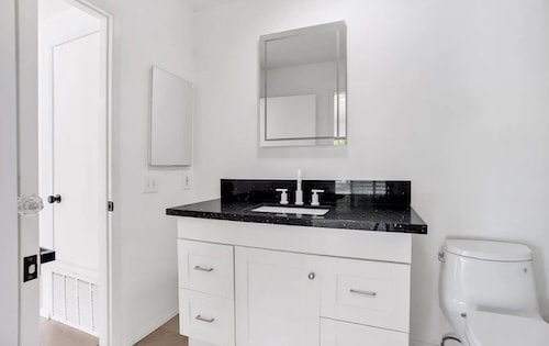 Modern bathroom remodel and renovation completed in a Southern California house by Ruiz Home Buyers.
